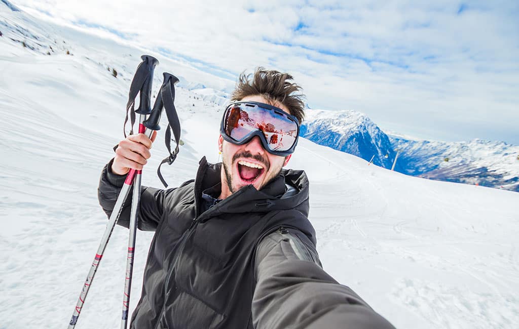 Man skis outdoors in the winter near Palmer Alaska with health smile from treatment at Evergreen Dental.
